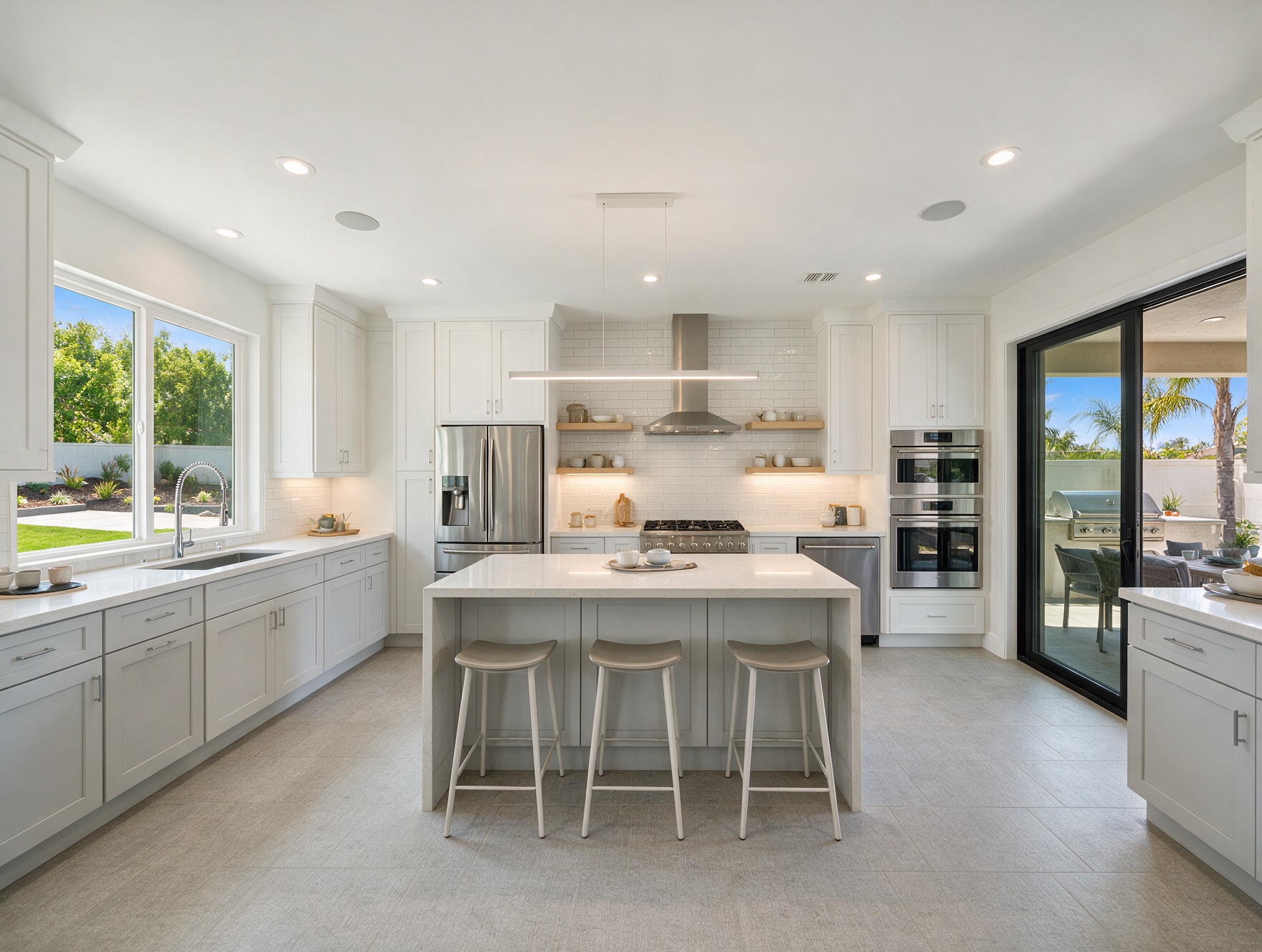 Modern white kitchen remodel in San Diego with island and quartz counters